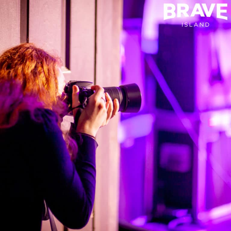 Young Isle of Wight photographer taking photos of a music gig