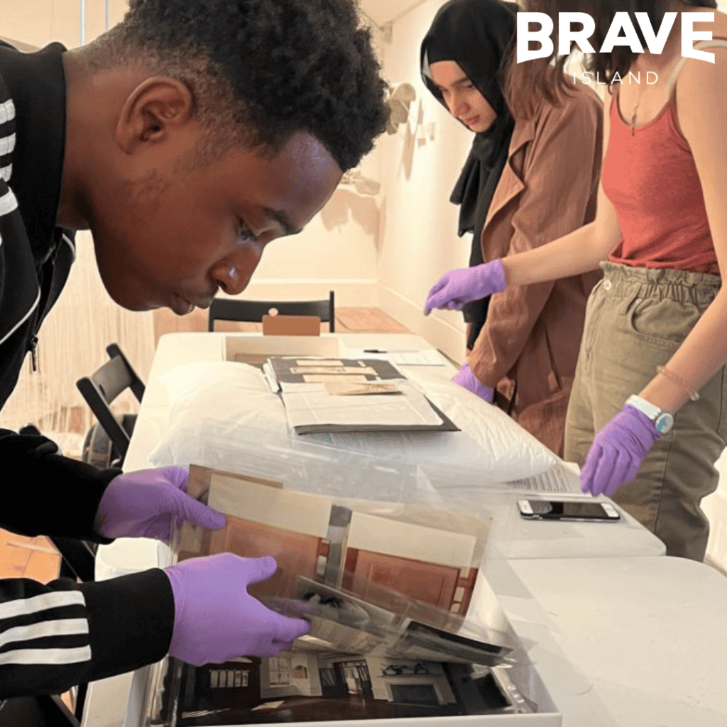 Group of young people looking through museum archives