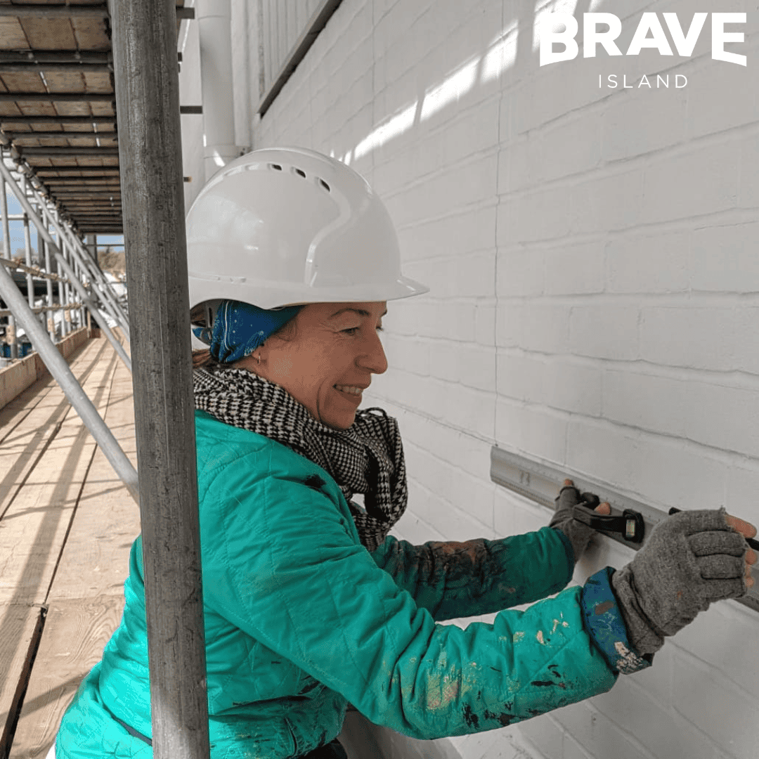 artist alice malia prepping a wall for mural painting