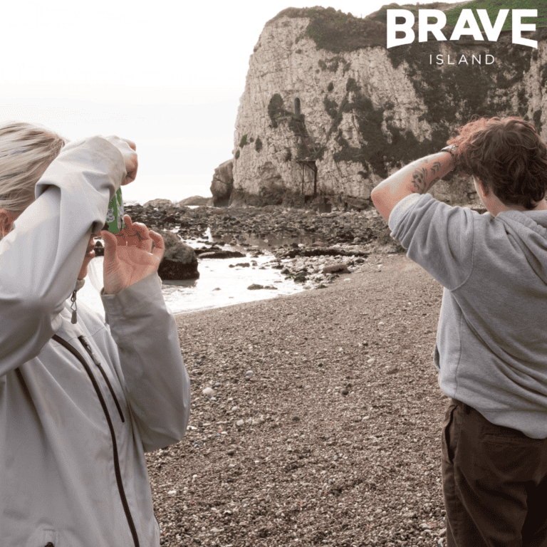 Two young people taking photos on cameras at Freshwater Bay