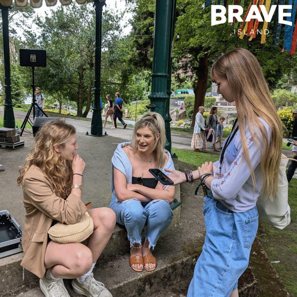 Three young women, two sat and one standing. Abbie Goodrem, singer songwriter (middle) is being interviewed by two members of the Fringe Review Team