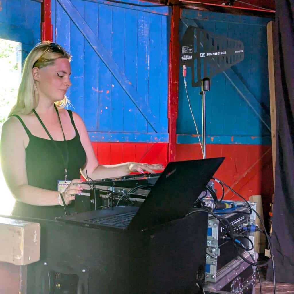 A photograph of a young person operating a sound desk at Bosco Theatre at Ventnor Fringe.